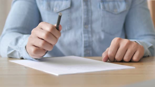 Tense Pensive Man Writing on Paper alt