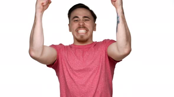 Portrait of Thrilled Man Rejoicing and Enjoying His Aims with Clenching Fists Like Winner Isolated alt