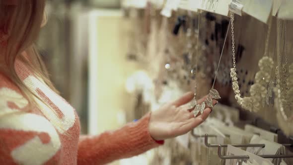 Young Beautiful Girl Chooses Decorations alt