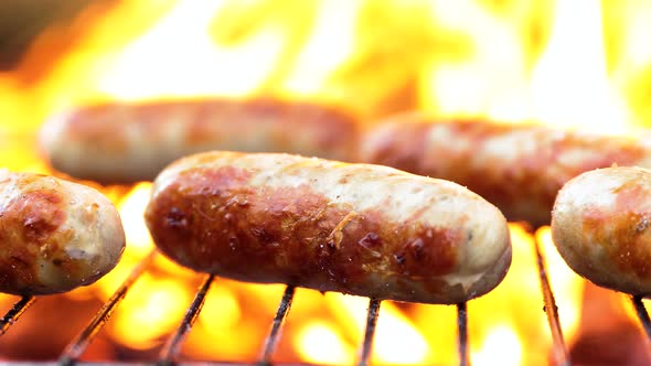Delicious Juicy Sausages Cooked on the Grill with a Fire alt