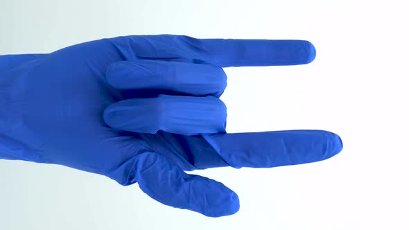 Vertical orientation video: Hand dummy of a medical gloved. Wooden hand of a blue latex gloved