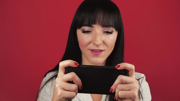 Gambling Young Woman Girl 30s Years Old in Shirt Posing Using Play Mobile Cell Phone Hold Gadget alt