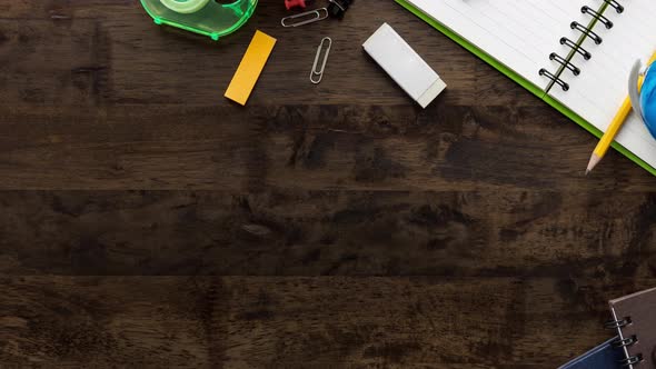Notebook and stationery on wood table with copy space for education background concept top view
