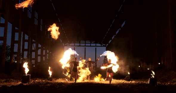 Four Women in Leather Clothes with Fire Dance and Show Fire Show a Man with a Flamethrower in the alt
