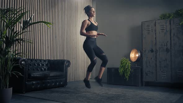 Athletic Brunette Woman is Doing High Knee at Home alt