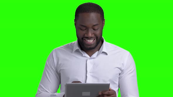 Cheerful Afro-american Guy Using Computer Tablet. alt