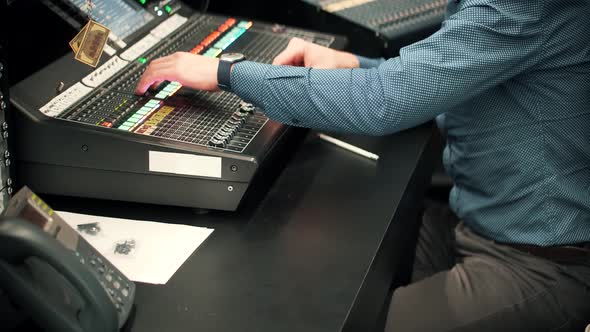 Recording Studio Sound Engineer Moving Sliders In Radio Station.Soundboard Pads Key On TV Station. alt
