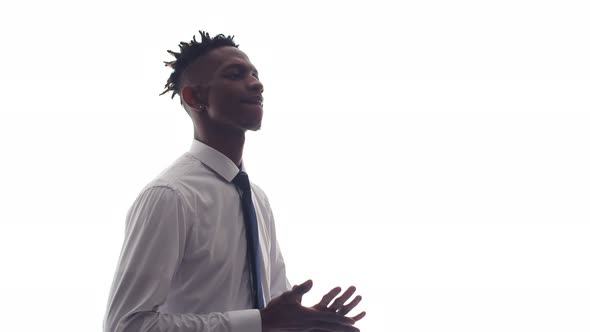 Office Black Man Rubs Palms and Puts Hands Cross on Chest alt