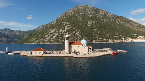Tourists Stand in Front of the Entrance to the Church of Our Lady of the Rocks alt