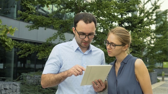Young and Smart Business People Standing Outside the Office alt