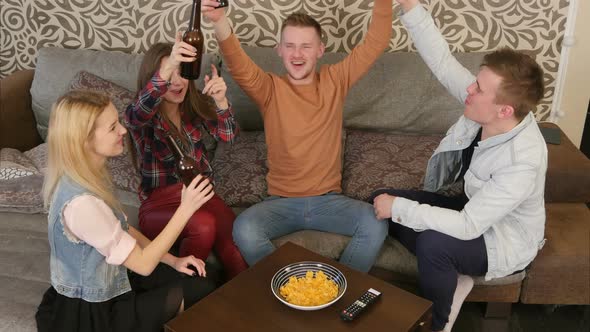 Group of Students Clinking Bottles of Beer alt