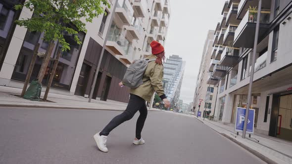 Hipster Woman Spinning in the Center of a City alt