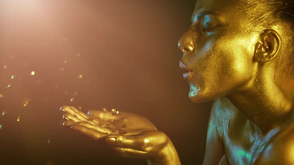 Golden Metal Beautiful makeup paint on beautiful model woman face close-up