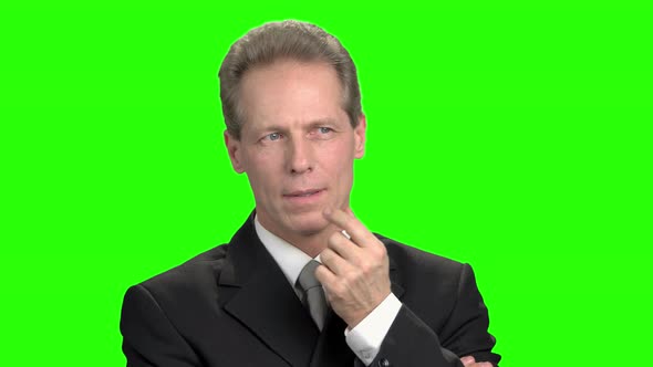 Pensive Mature Businessman in Suit. alt