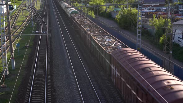 Freight Train Carries Cargo. View of the Train From Above. Rail Transport for Intercity Trade. alt