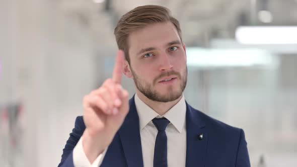 No Sign By Young Businessman By Finger Gesture alt