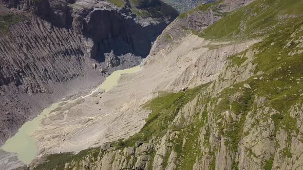 Aerial shot of a wild transformed valley in the Swiss alps in the Grindelwald region alt