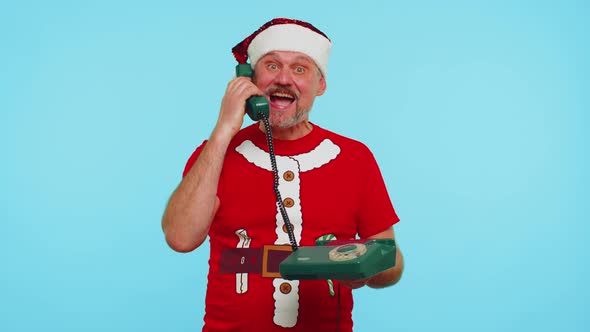 Funny Man in Christmas Tshirt Talking on Wired Vintage Telephone of 80s Says Hey you Call Me Back alt