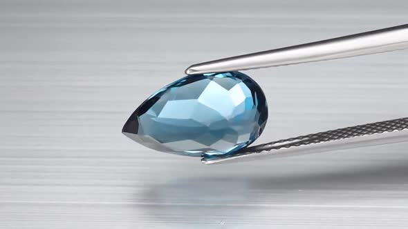Natural London Blue Topaz Pear Cut in the Turning Tweezers