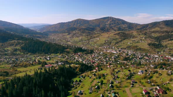 Drone Flight Over Forest and Buildings in Carpathians alt