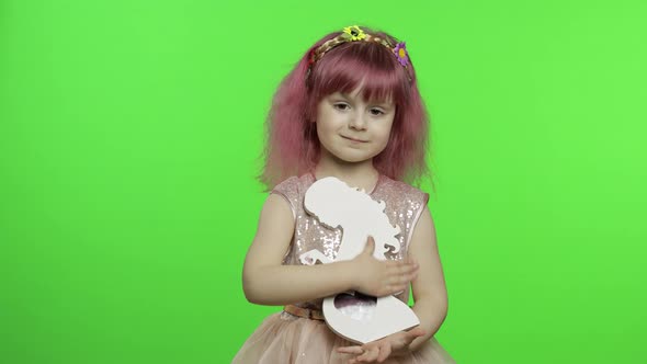 Girl Holds Holds Wooden Photo Frame in the Form of Pregnant Woman. Mother's Day alt