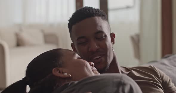 Diverse Couple Cuddling on Sofa alt