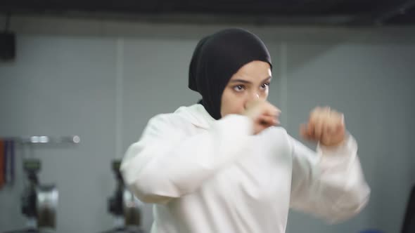 Sporty Muslim Woman Works Out in the Gym She Wears a Sporty Hijab