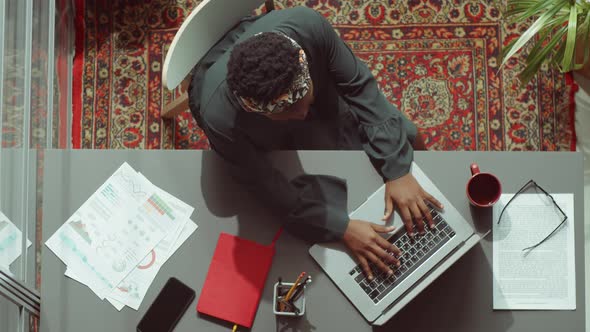 Top Down Portrait of African American Businesswoman at Office Desk alt