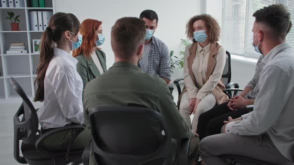 Therapy Sessions in Quarantine Young Men and Women Wearing Medical Masks to Protect Against Virus alt