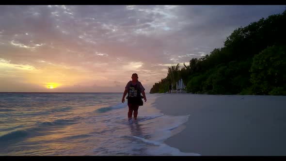 One woman suntans on tropical shore beach break by turquoise sea and white sand background of the Ma alt
