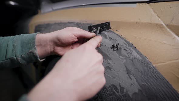 A Close-up of a Man's Hand with a Tool. A Professional Removes the Form From the Clay with the Help alt