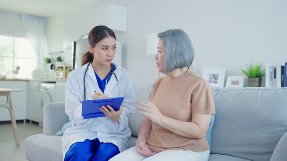 Asian caregiver psychology doctor examine and listen to woman patient alt