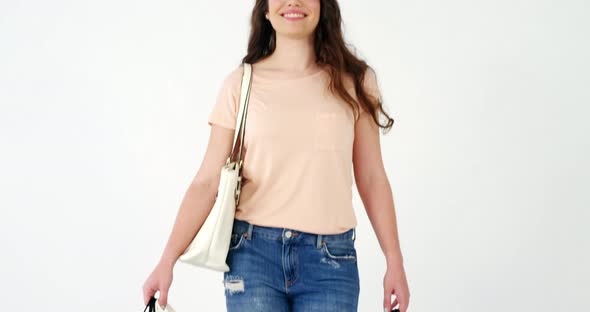Portrait of smiling woman holding a shopping bag alt