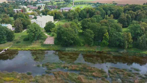 Aerial Shot City Mezotne, Latvia Republic. Mezotne Palace and Park With Fountain. Lielupe River With alt
