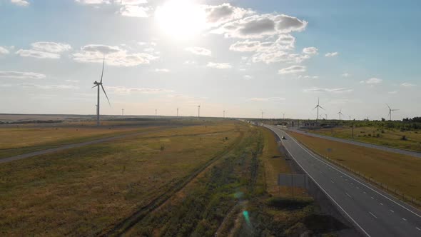 Aerial View of Wind Turbine on a Field in a Summer Day. Environment Friendly and Renewable Energy alt