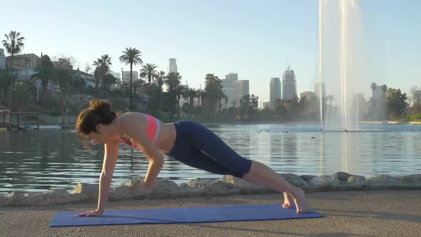 Woman Doing Yoga In The Park At Dawn alt