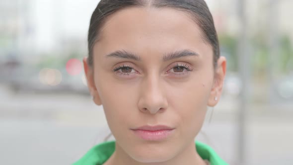 Close Up of Hispanic Woman Face Looking at the Camera Outdoor alt