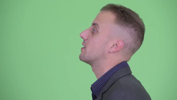 Closeup Profile View of Happy Businessman in Suit Talking alt