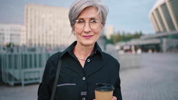 Portrait Senior Business Woman Smiling Confident Independent Female in City Wearing Black Shirt alt