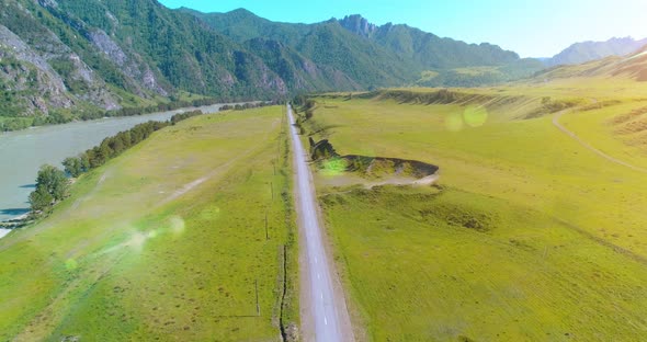 Aerial Rural Mountain Road and Meadow at Sunny Summer Morning alt