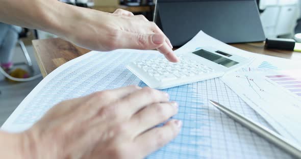 Woman is Counting Financial Statistics on Calculator Slow Motion  Movie alt