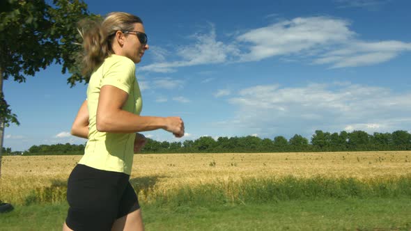 Woman Running Beside Field