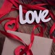 Rotating Valentine&#39;s Day Background with Boxes Gifts Red Ribbons and Hearts and the Inscription Love - VideoHive Item for Sale