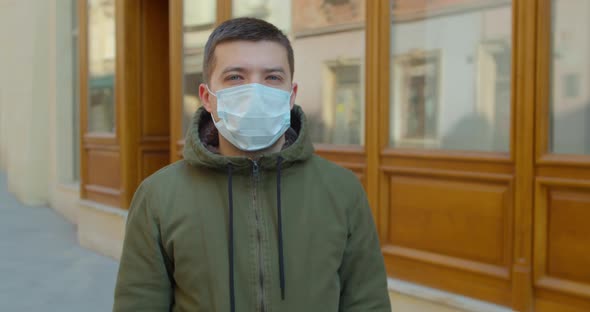 Pandemic Protection of the Covid-19 Coronavirus. Portrait of a Caucasian Man in a Medical Face Mask alt