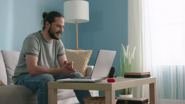 Man Is Talking with Friend Via Laptop
