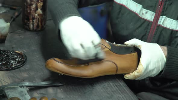 Shoemaker Is Painting Leather Shoes