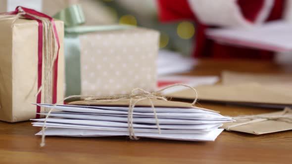 Hands of Santa Claus Reading Letters at Desk alt