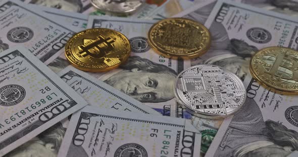 Close Up of Metal Shiny Bitcoin Crypto Currency Coins on US Dollar Bills alt