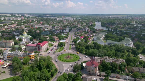 Aerial View of Roundabout Road with Circular Cars in Small European City at Sunny Day alt