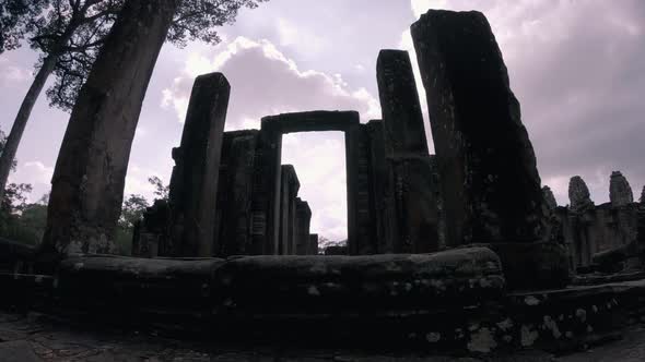 Timelapse of Temple at Angkor Wat Complex - Pillars Silhouetted Against the Sun alt